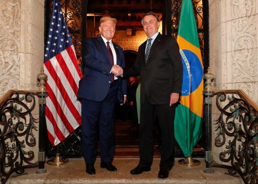 U.S. President Donald Trump and Brazilian President Jair Bolsonaro shaking hands.