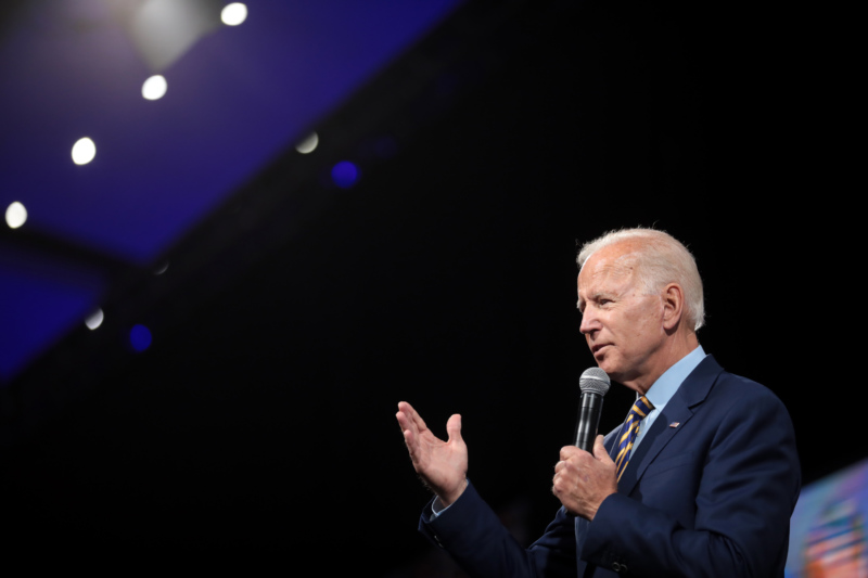 Close-up of Joe Biden speaking to a crowd with a dark background