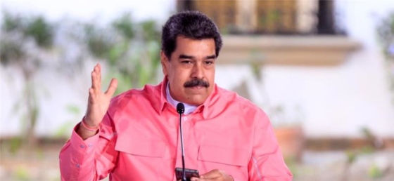 Venezuelan President Nicolás Maduro speaking into a microphone.
