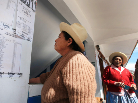 Women checks where to cast her vote