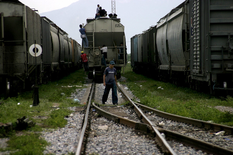 Central American migrants hop a freight train in Ciudad Ixtepec, Mexico