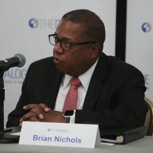 Photo of Brian Nichols speaking into a microphone