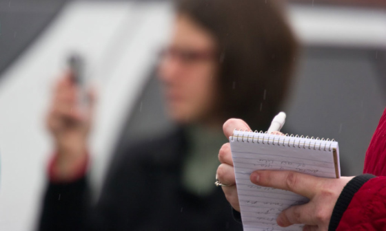 Photo of Journalists writing on notepads