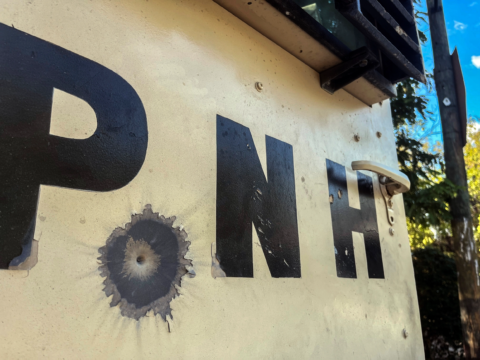 Photo of Police Nationale d'Haiti wall with bullet holes